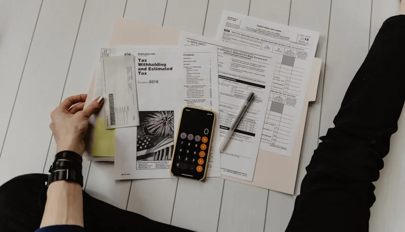 Financial documents and a calculator on a desk